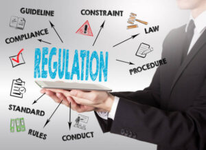 Regulation, young man holding a tablet computer on a gray background